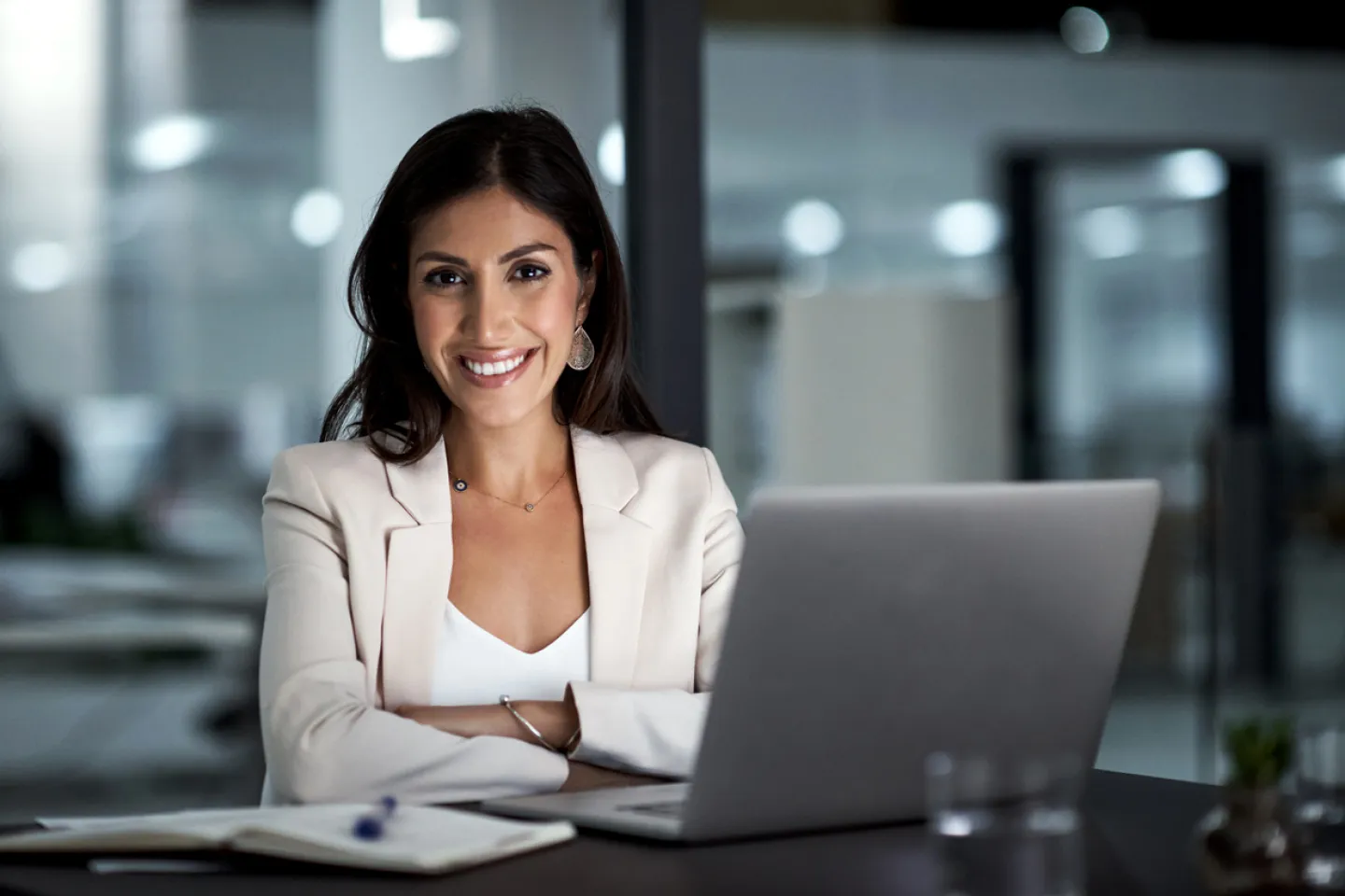 Smiling Business women sitting at desk in front of laptop